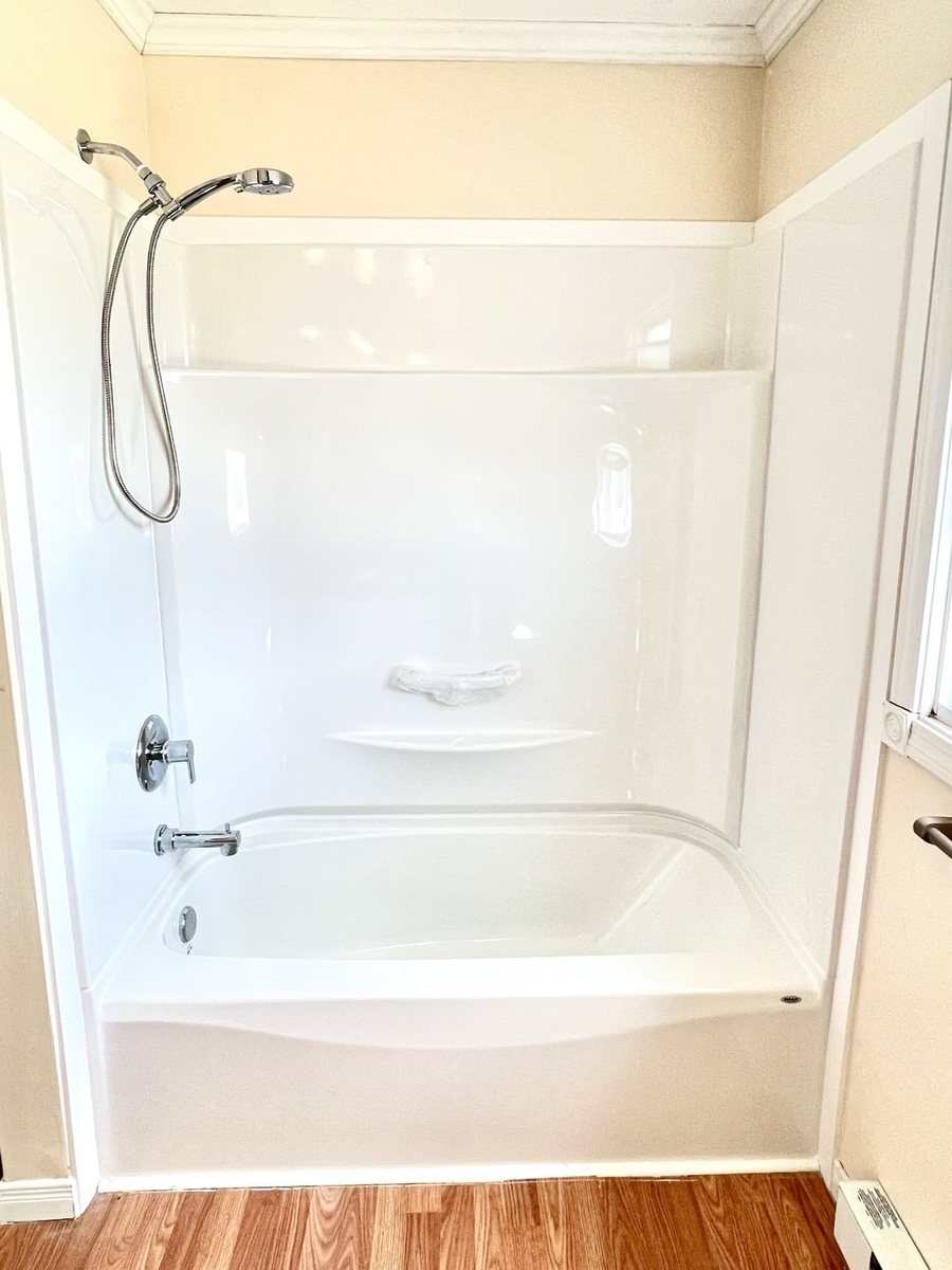 A finished tub and shower unit by High-5 Renovations