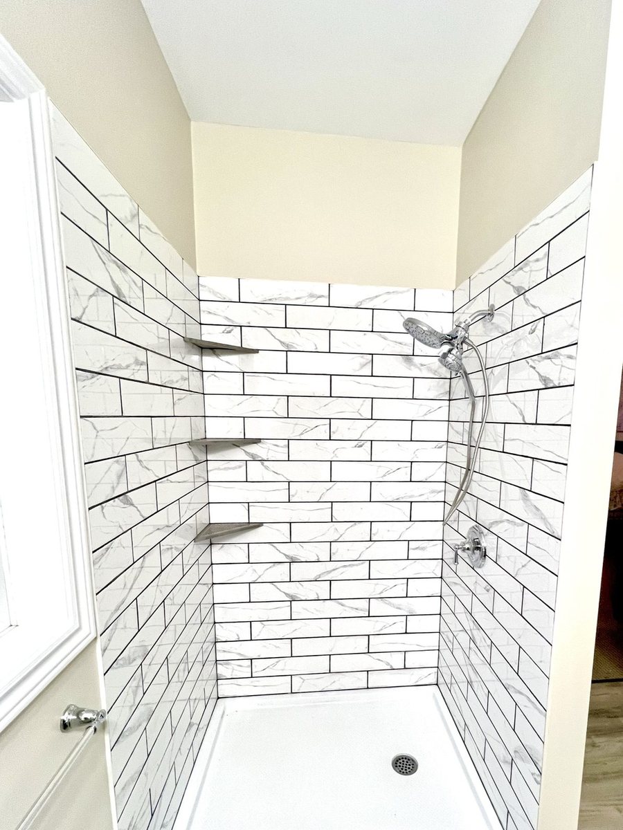 A tiled shower finished by High-5 Renovations
