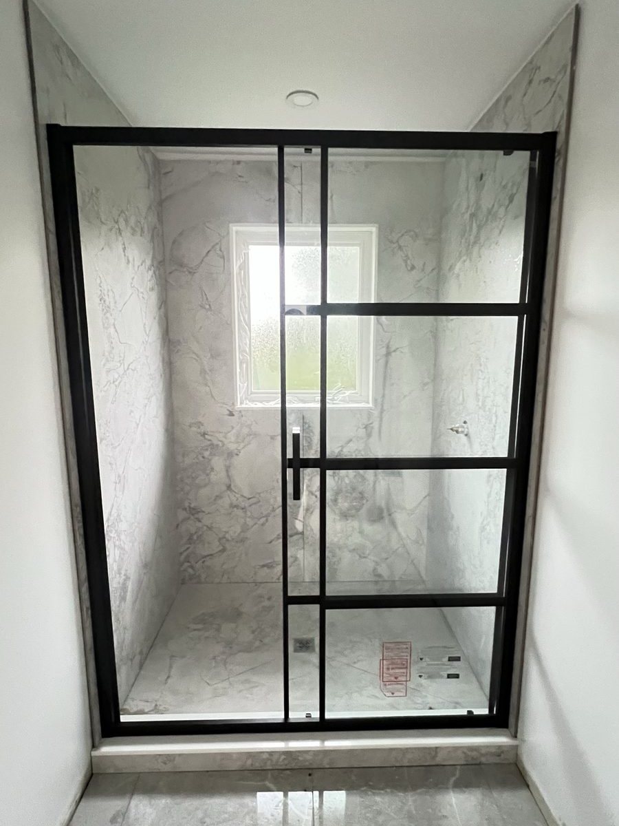 A glass shower enclosure finished by High-5 Renovations