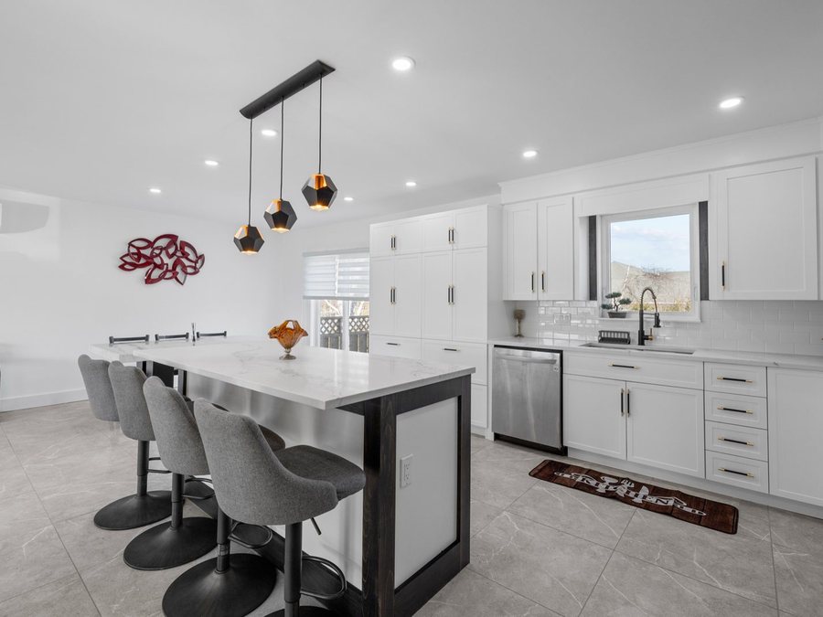 A kitchen island and cabinets by High-5 Renovations